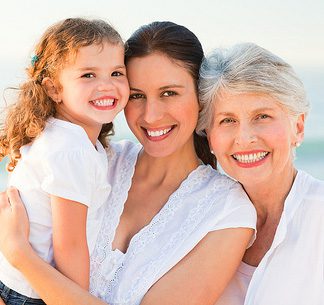 A girl, a woman and an old woman all smiling and happy